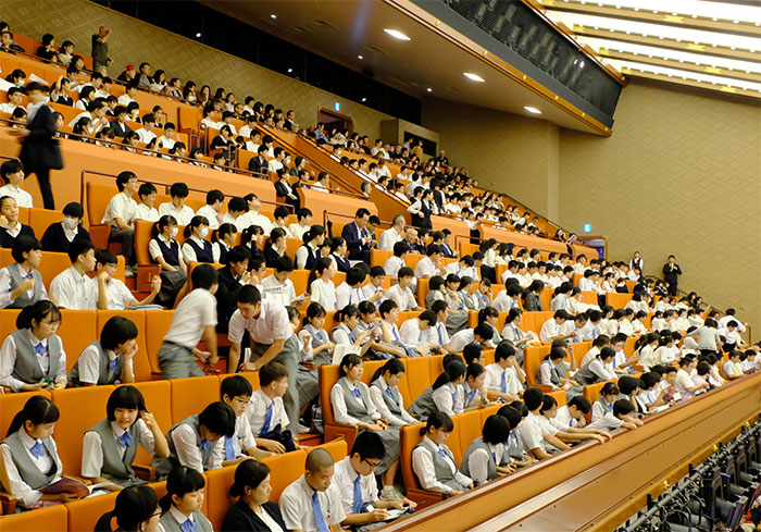 Middle school students watching a play as part of their course work