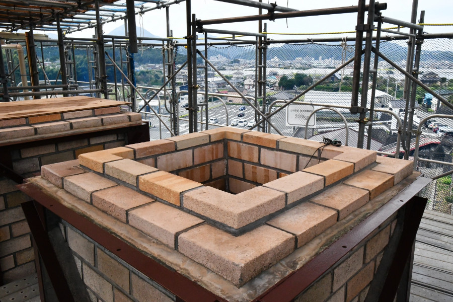 This precious photo of the smokestack opening could not be taken without scaffolding.